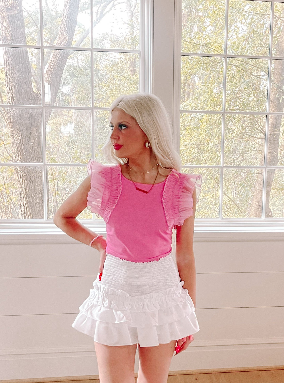 Frillmingo Pink Top:  Hot pink ruffle top with sheer overlay sleeves, perfect for summer.
