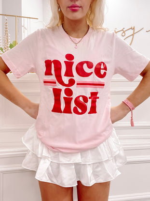 Pink 'Nice List' tee with red retro lettering.