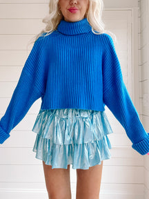 Bright blue ribbed knit Sydney sweater; cozy, oversized fit.
