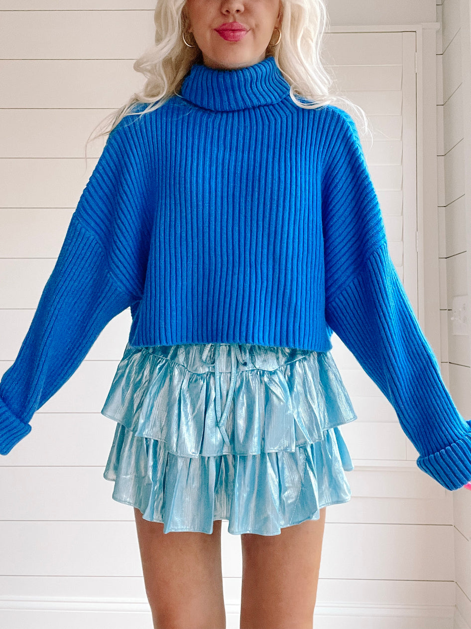 Bright blue ribbed knit Sydney sweater; cozy, oversized fit.
