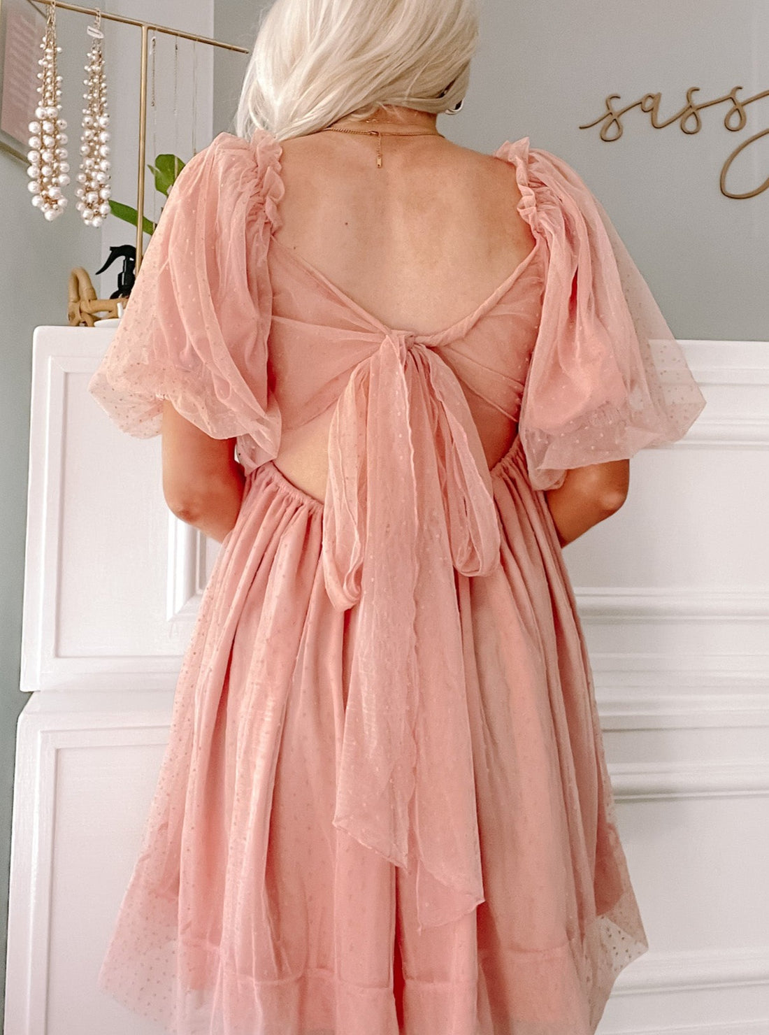 Dusty rose mini dress with puff sleeves and a back bow detail.

