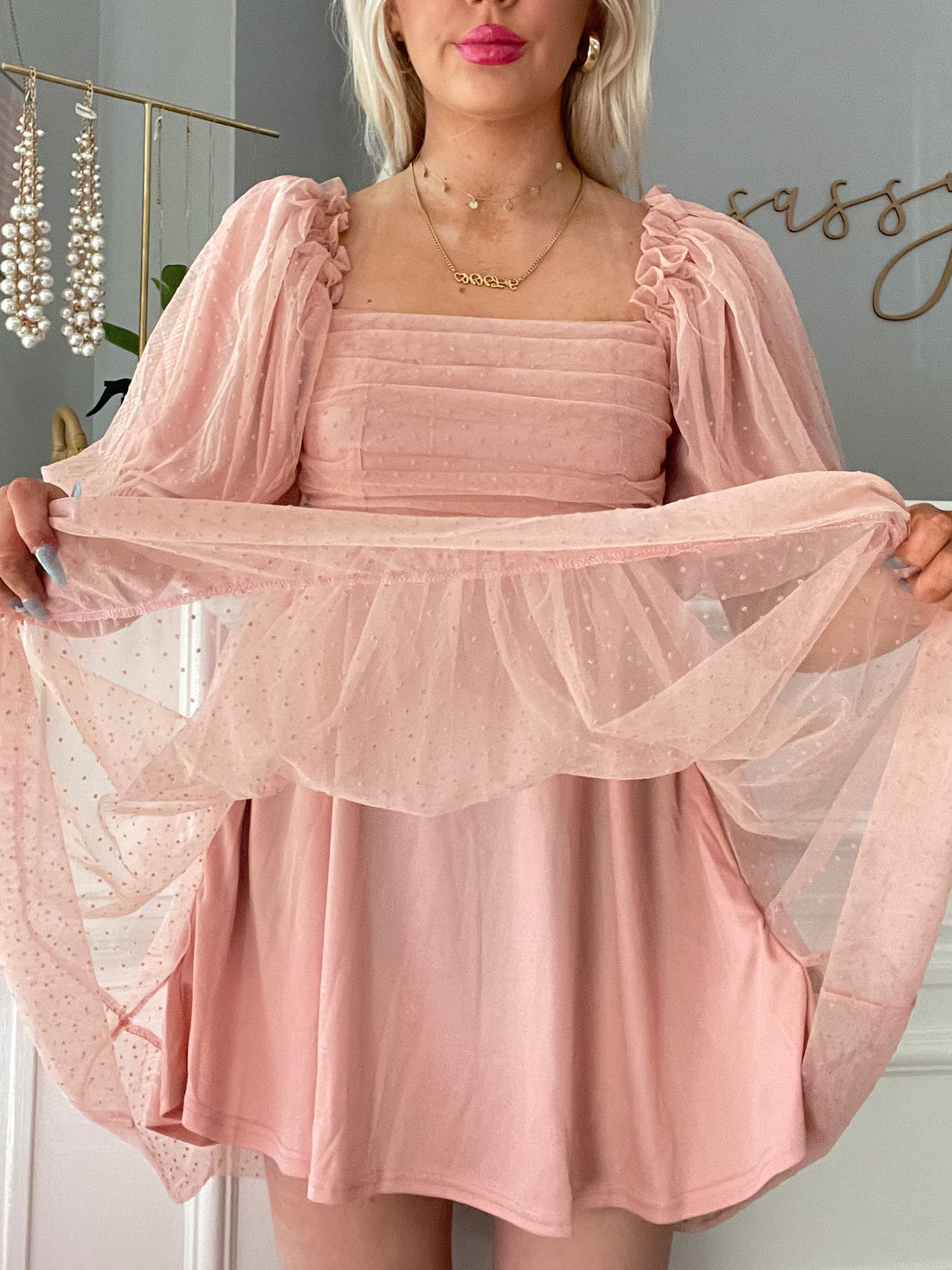 Blush pink mini dress with puff sleeves and Swiss dot overlay; shown on model.
