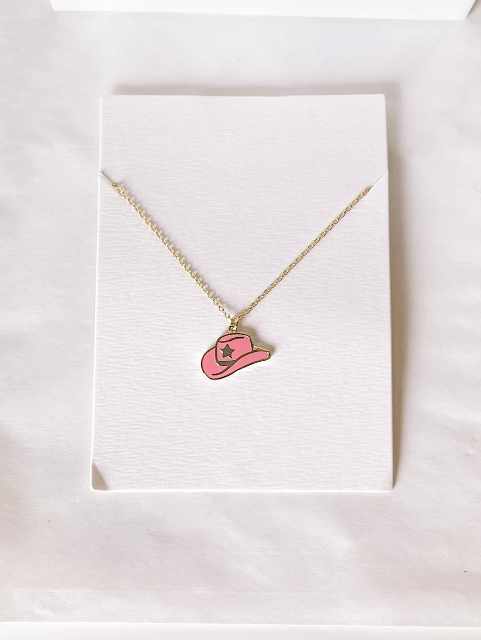 Gold chain necklace with a pink cowboy hat charm.

