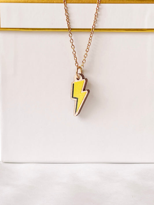 Strikes Twice Necklace: Gold chain with yellow lightning bolt wood pendant.
