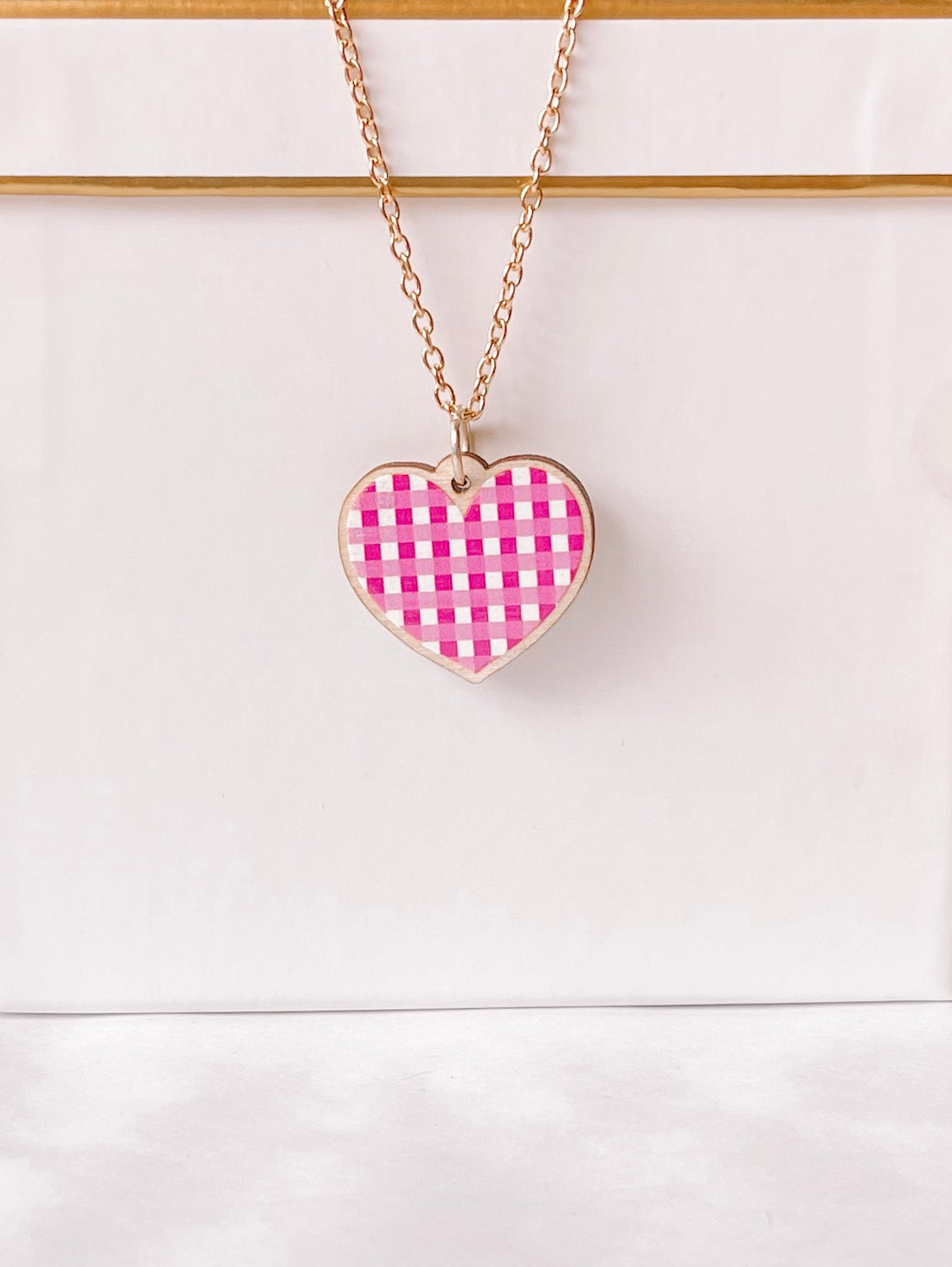 Pink gingham heart necklace with gold chain
