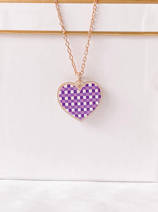 Rose gold chain necklace with a purple gingham heart pendant.
