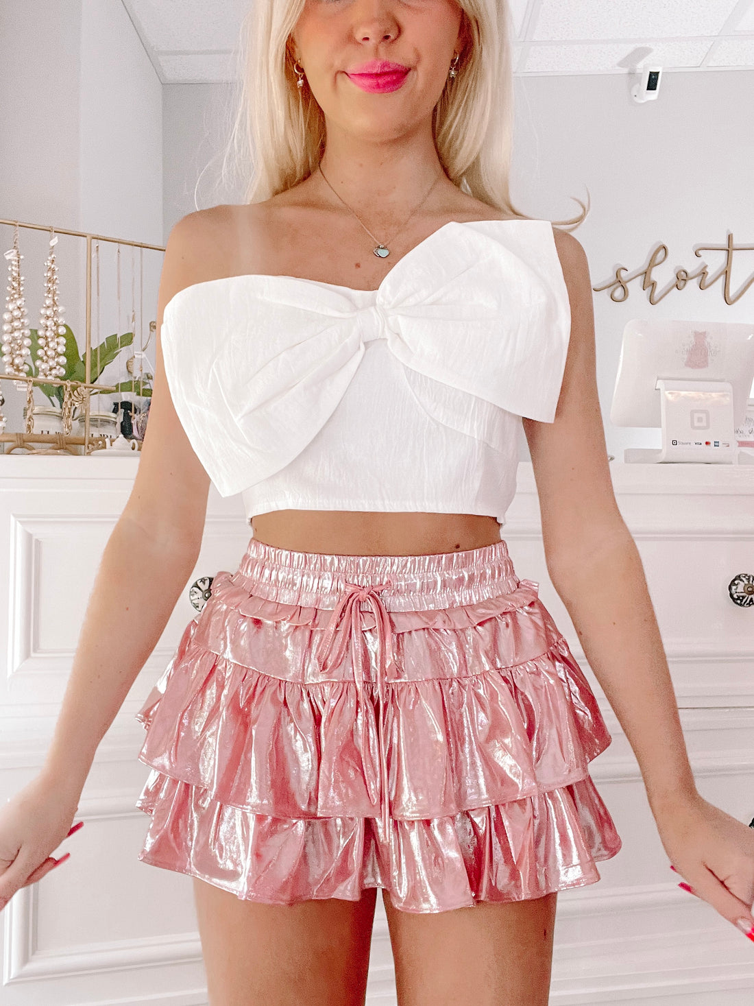 Pink Flirtatious Foil Skirt: shimmering ruffle mini skirt with drawstring waist.
