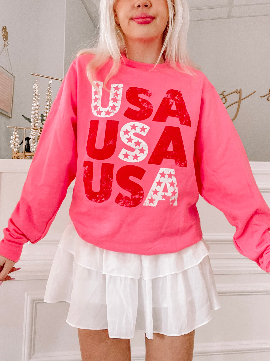 Pink USA sweatshirt with red and white distressed USA graphic
