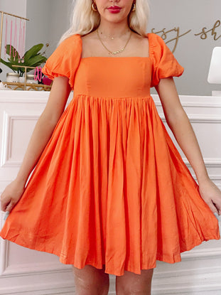 Orange citrus Lush and Lemons dress with puff sleeves and square neckline.
