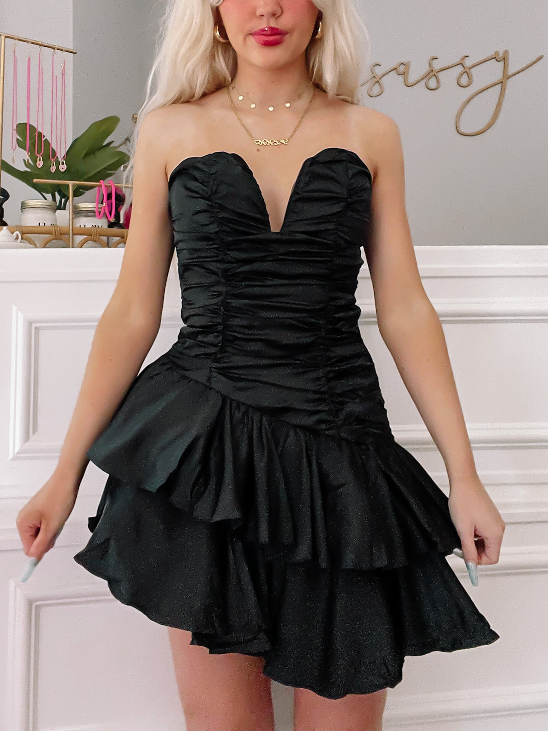 Black strapless ruffle mini dress; perfect for parties.
