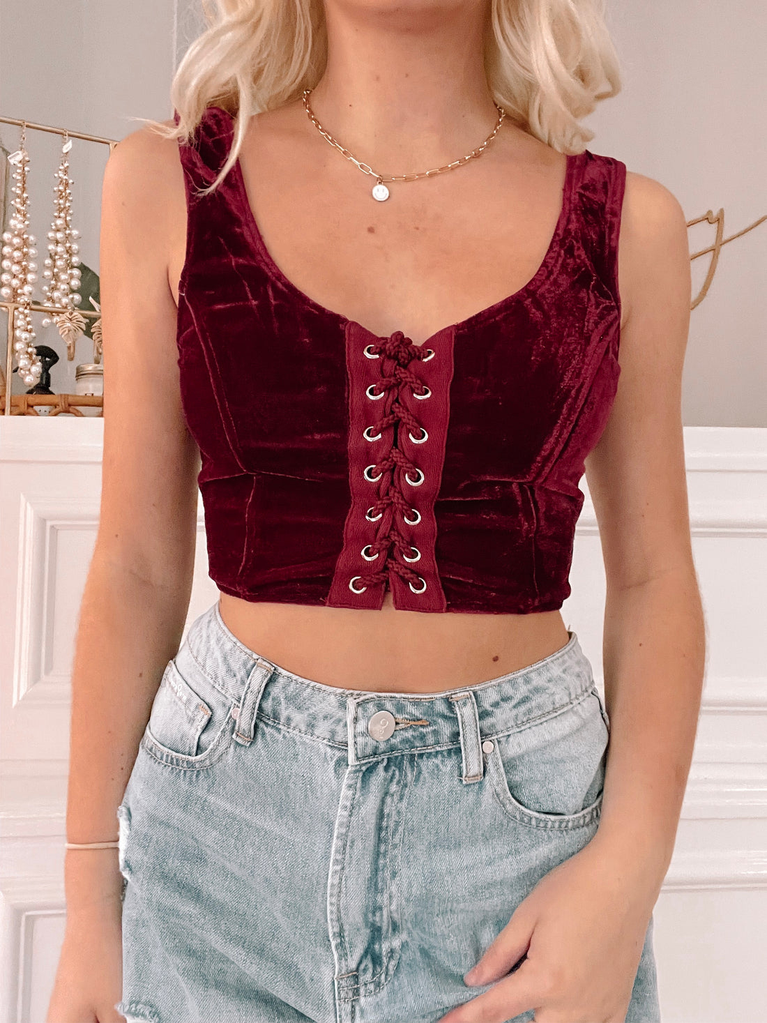 Red velvet corset top with lace-up front detail

