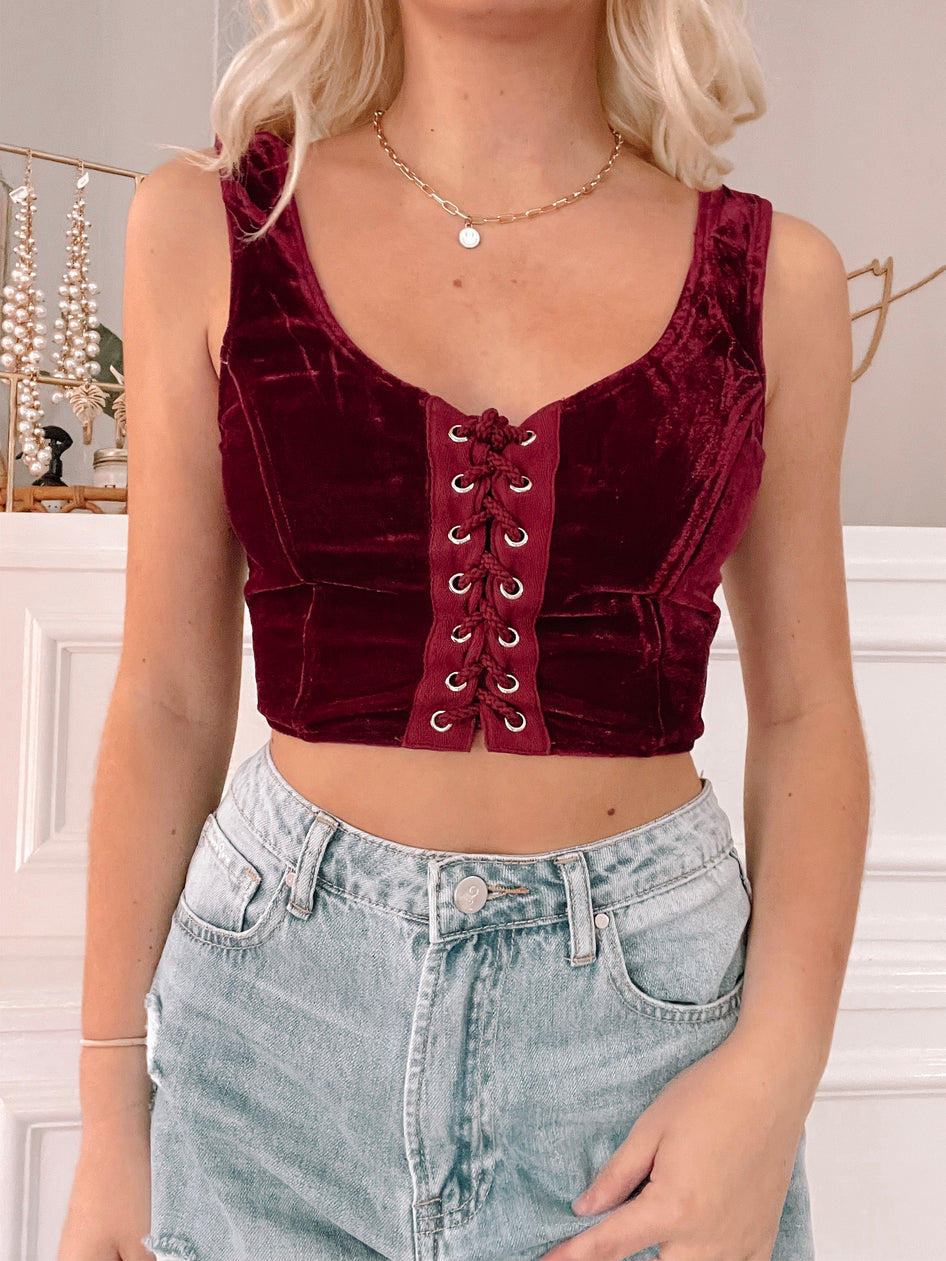 Red velvet corset top with lace-up front detail
