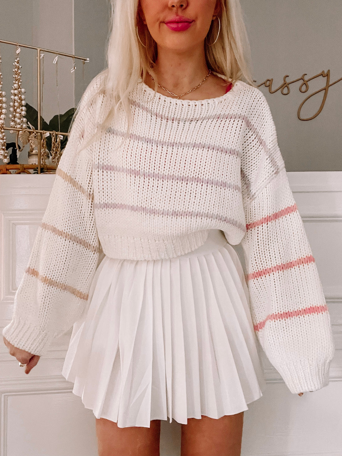 Cream-colored striped Wonderland sweater with balloon sleeves; perfect for a casual look.
