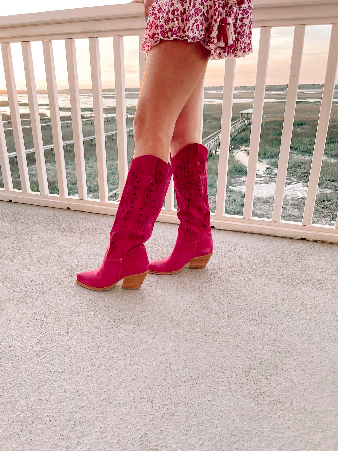 Pink suede City Girl boots with cutout detailing and wooden heels.

