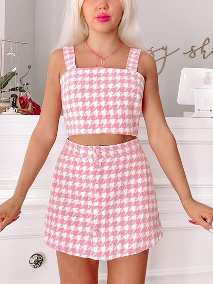 Pink houndstooth print two-piece set: cropped top & mini skirt.
