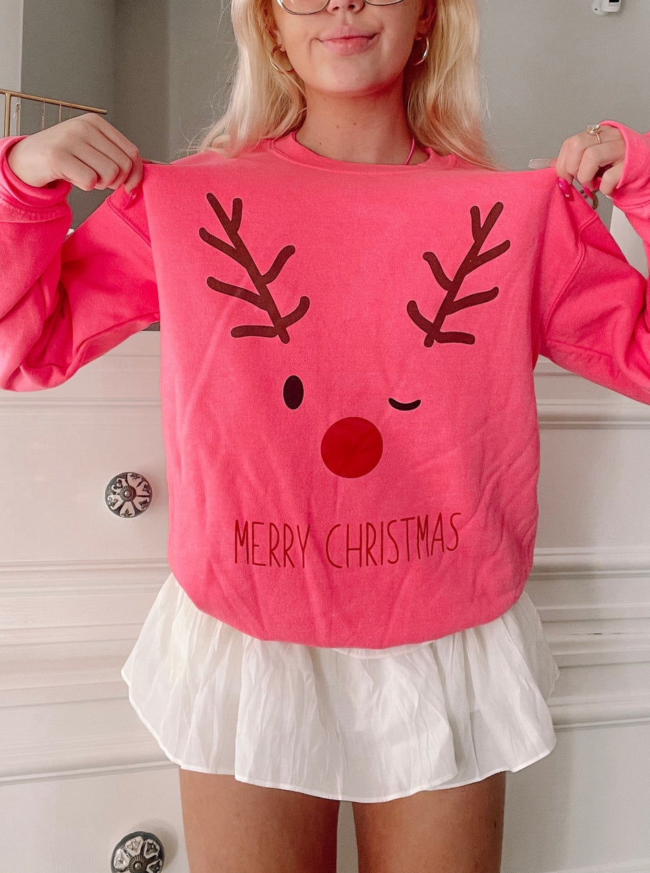 Pink Christmas reindeer crewneck sweatshirt with "Merry Christmas" text
