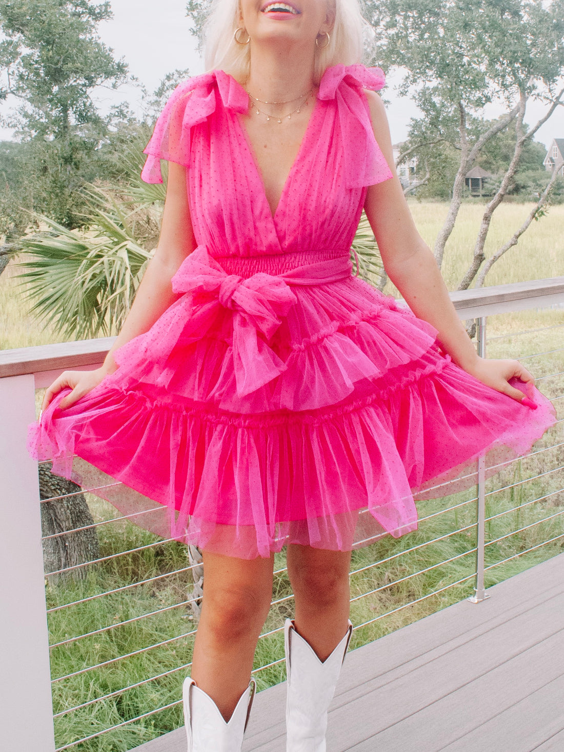 Hot pink tulle mini dress with bow details; perfect for parties.
