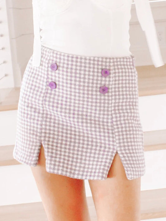 Purple houndstooth mini skort with side slits and purple buttons.