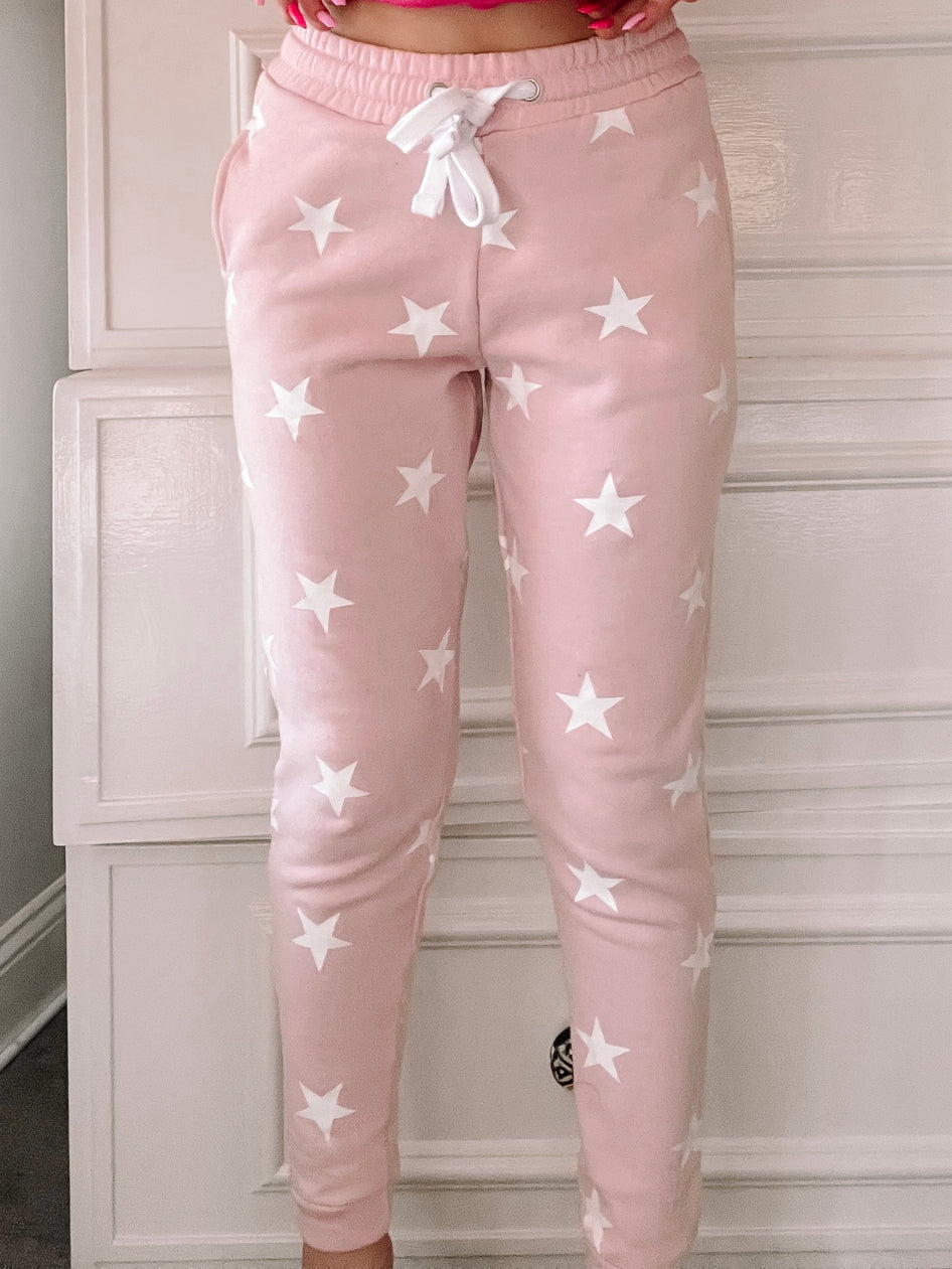 Pink Stargazer joggers with white star print
