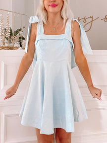 Light blue Girls Who Twirl dress with bow shoulder straps.
