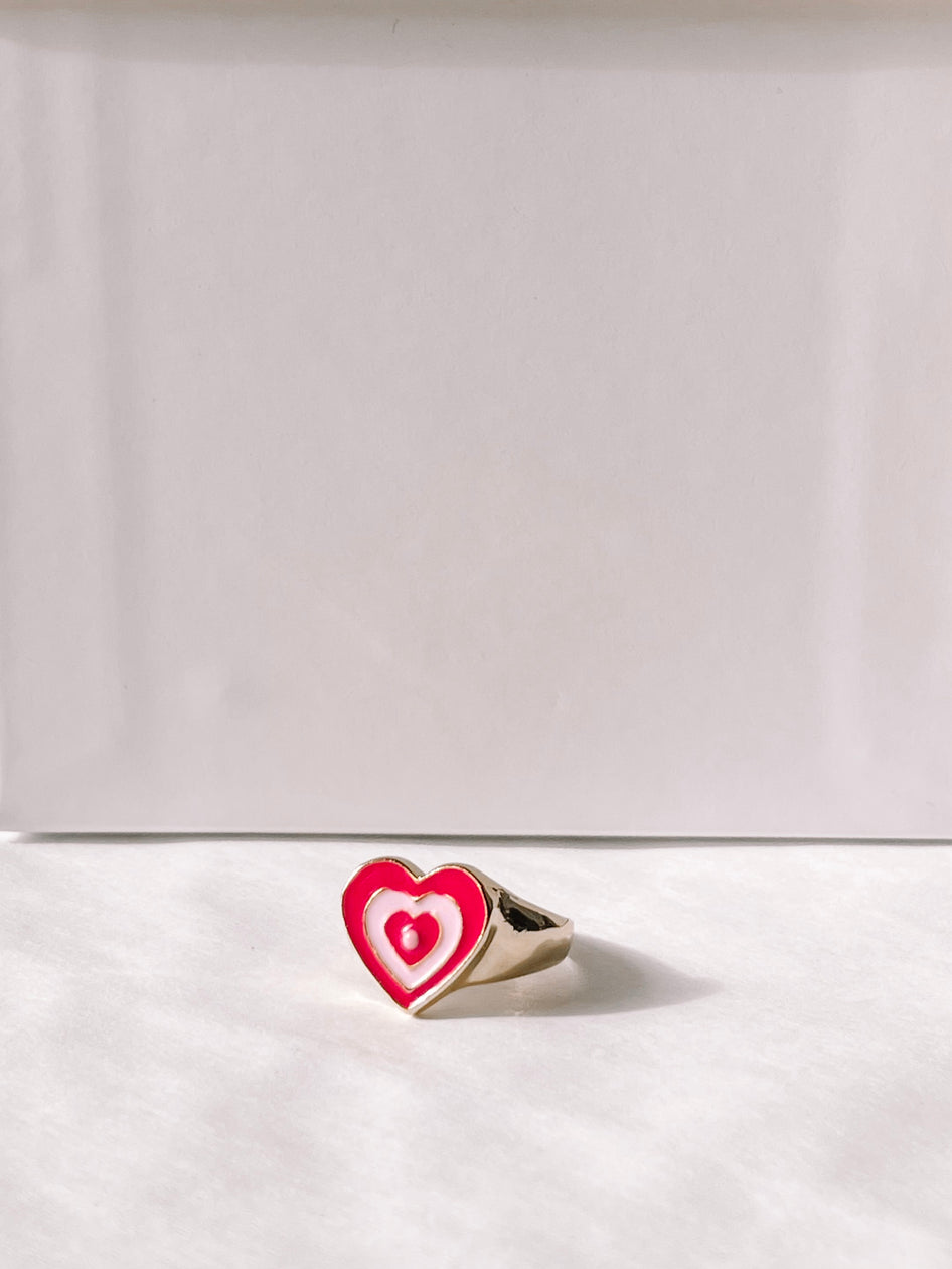 Gold Love Me ring with pink & white enamel heart.
