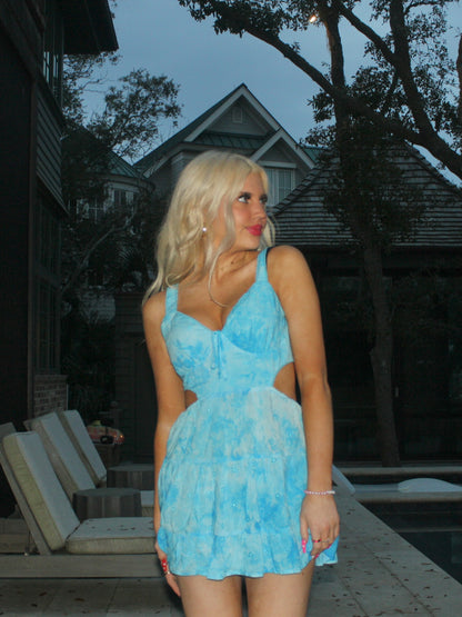 Light blue eyelet mini dress with cutouts, worn outdoors near a pool.

