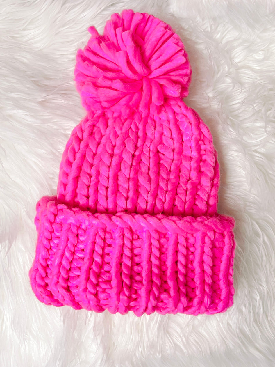 Electric pink chunky knit beanie with oversized pompom
