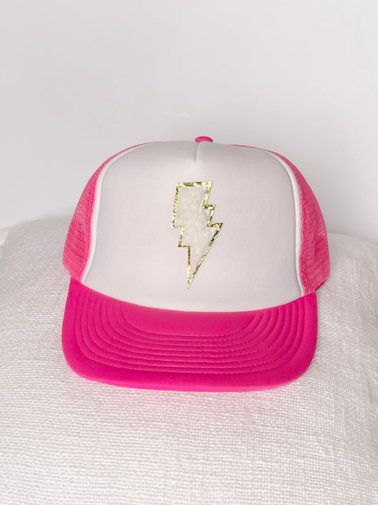 White Lightning Hat: White trucker hat with hot pink bill and gold lightning bolt detail.
