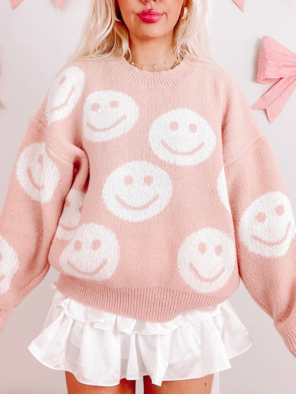 Light pink Miles of Smiles smiley face knit sweater
