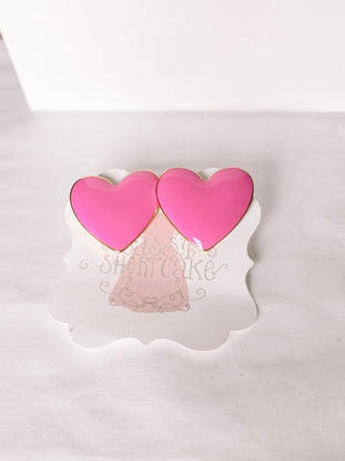 Peppy Pink Heart earrings:  Pink heart-shaped studs with gold accents.
