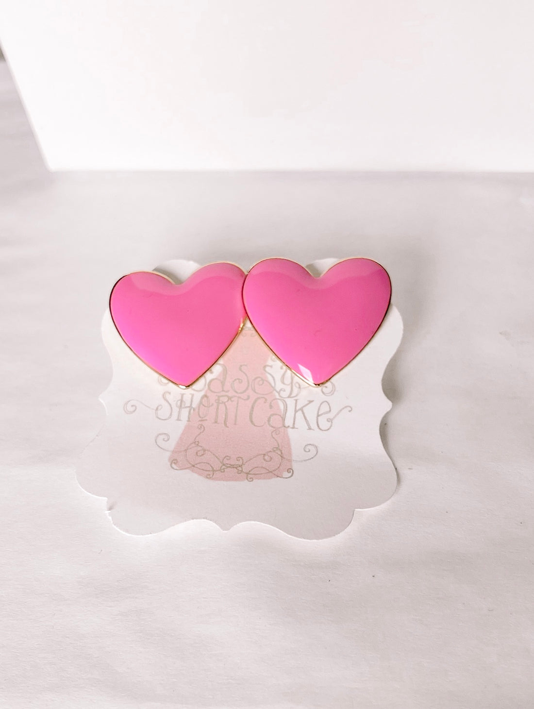 Peppy Pink Heart earrings:  Pink heart-shaped studs with gold accents.
