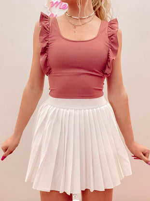 Dusty rose ruffle crop top & white pleated tennis skirt
