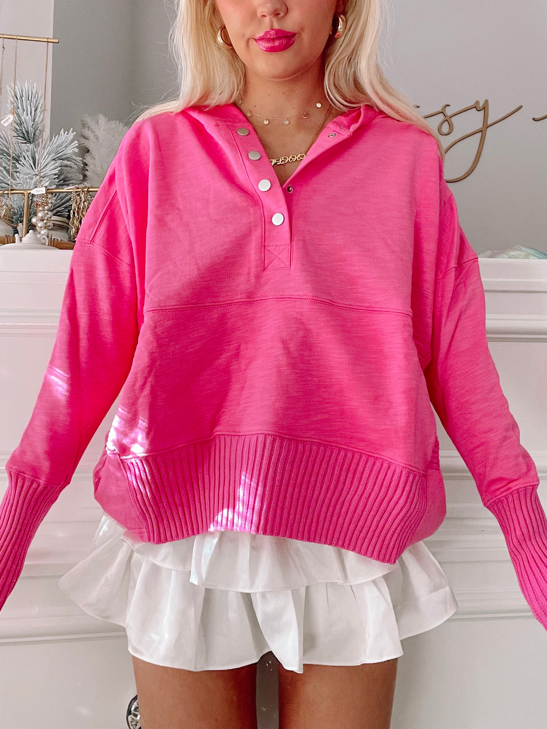 Hot pink Lana pullover sweater with button placket and ribbed cuffs.
