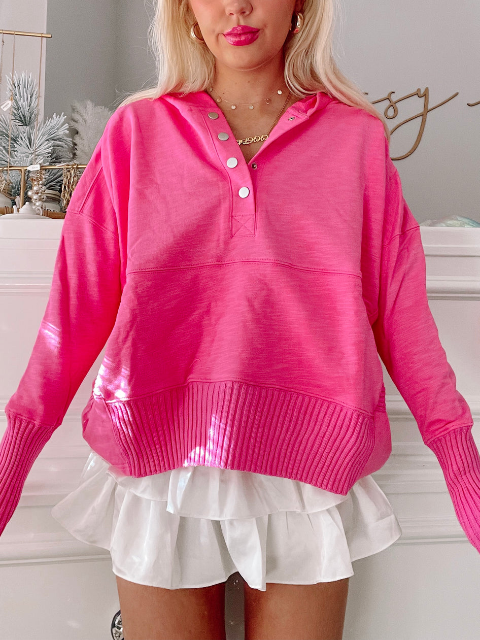 Hot pink Lana pullover sweater with button placket and ribbed cuffs.
