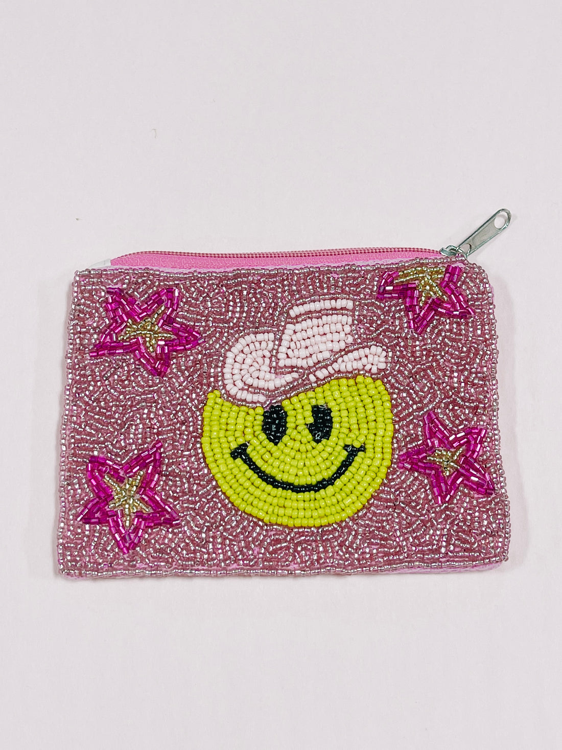 Pink beaded pouch with a smiling face design and stars.
