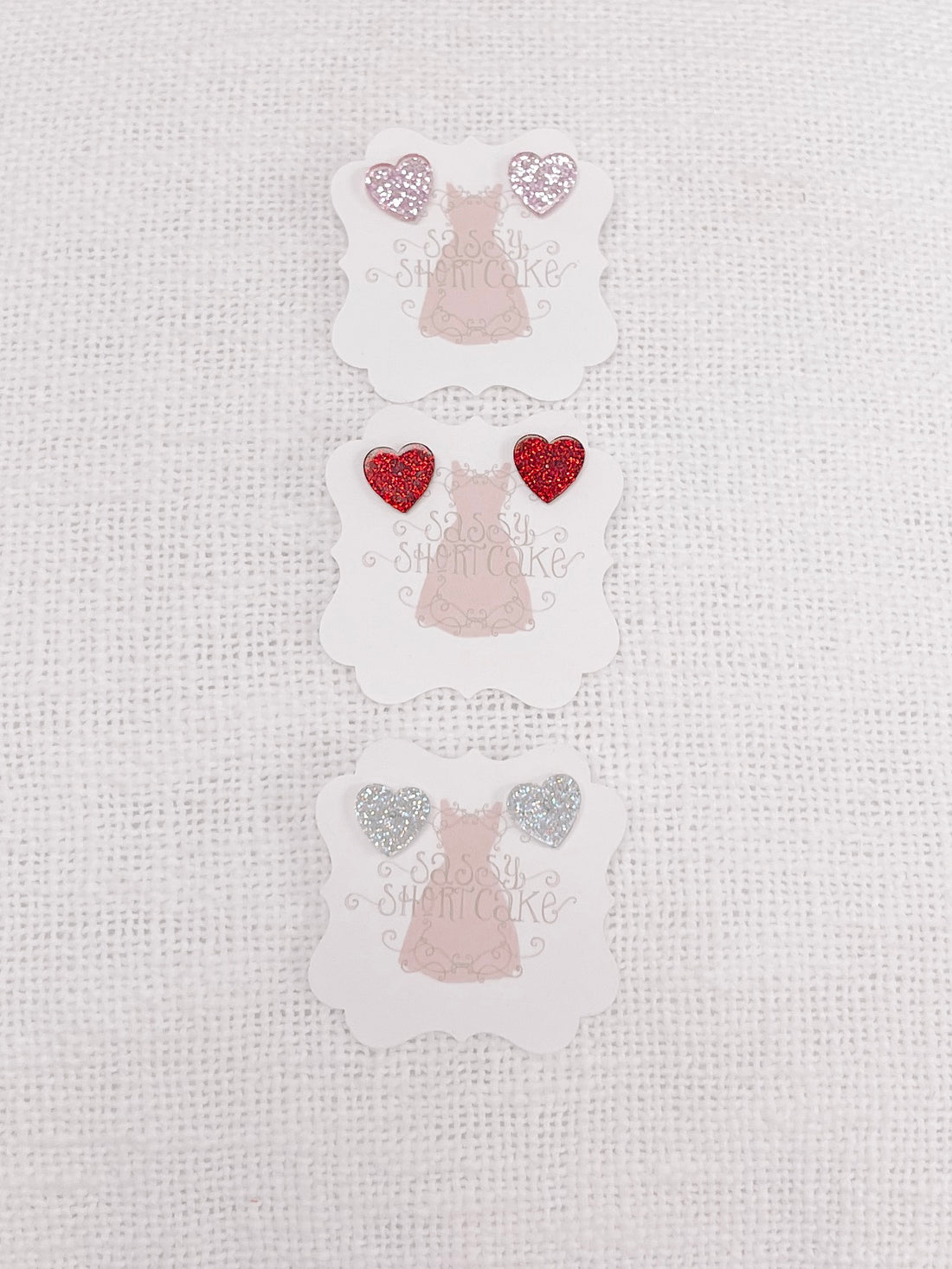 Sassy Shortcake Sparkle Sweet Heart glitter earrings; pink, red, silver.
