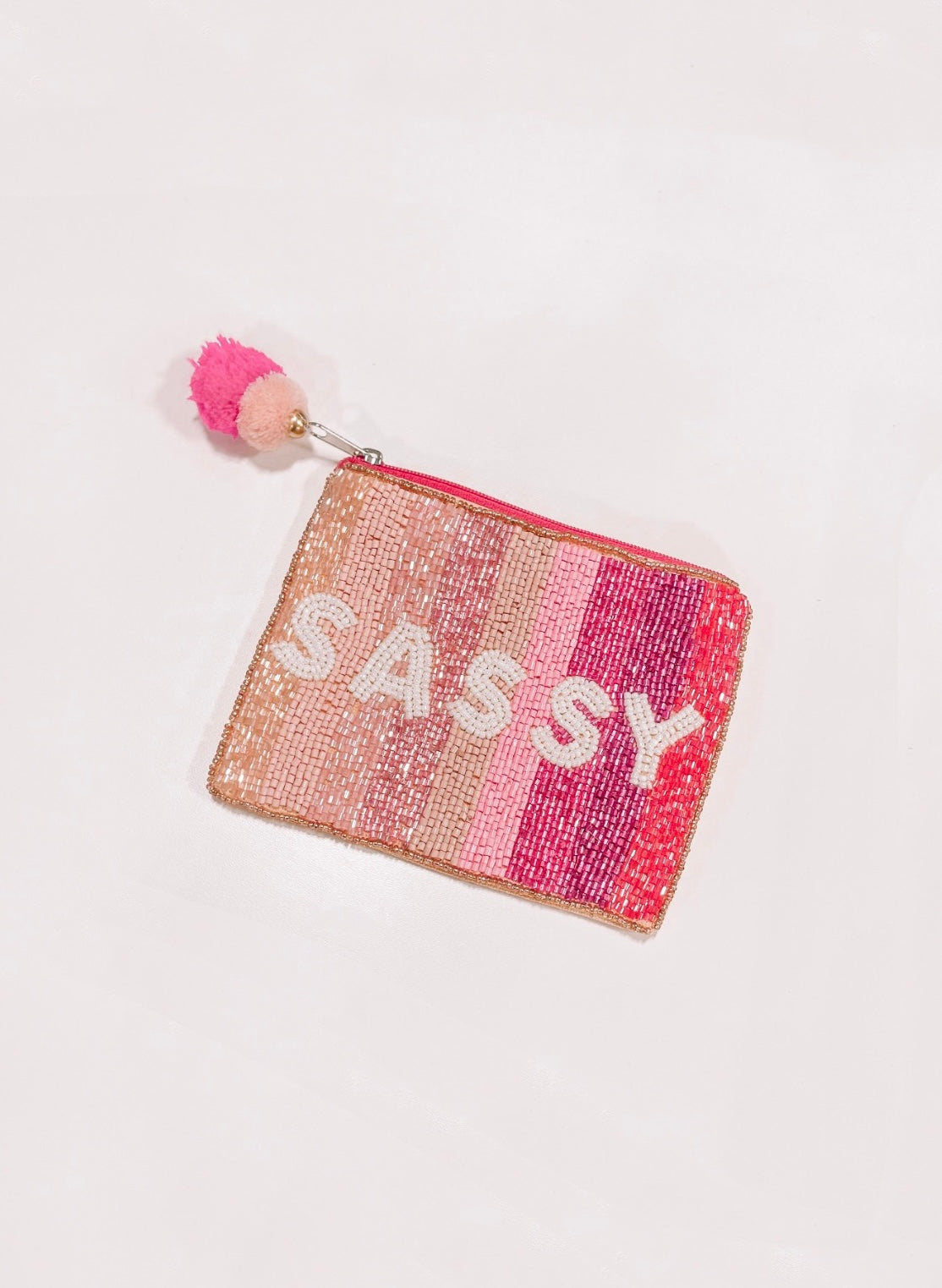 Beaded Sassy pouch with pink ombre design and pom-pom.
