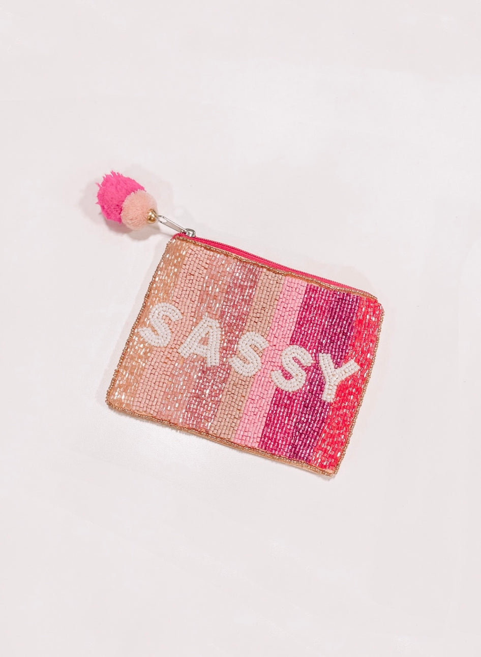 Beaded Sassy pouch with pink ombre design and pom-pom.
