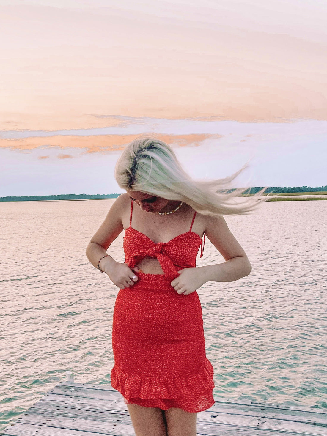 Red floral Shirley Temple dress with a cutout and tie detail.
