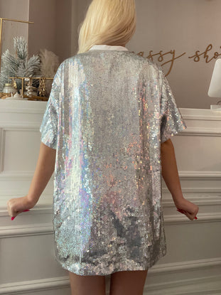Silver sequined mini dress shown from the back, iridescent sparkle, short sleeves.
