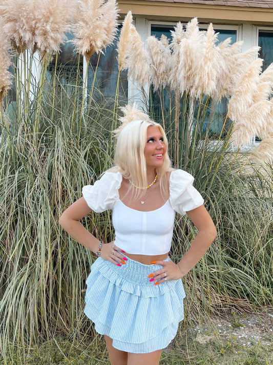 Newport Sweater White puff-sleeve crop top from Sassy Shortcake and light blue striped ruffle skirt
