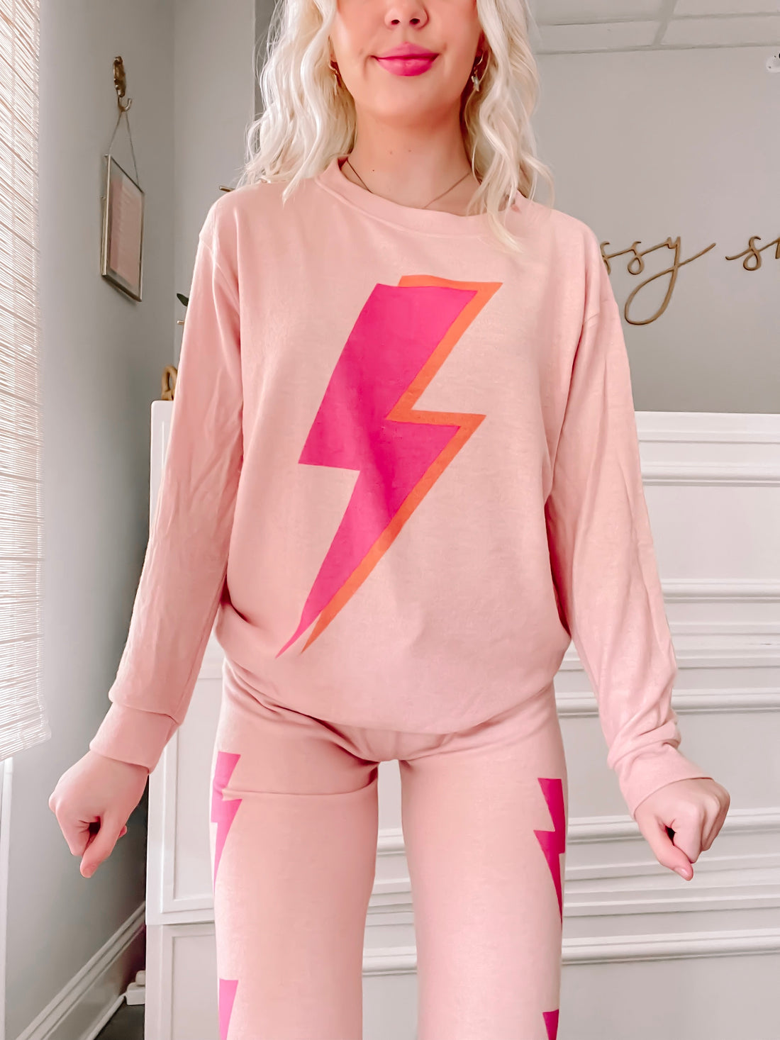 Pink lightning bolt pajama set; comfy long-sleeve top and leggings.
