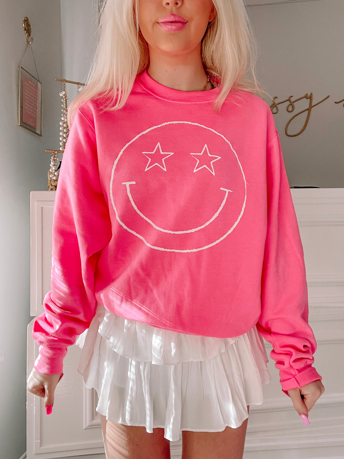 Pink Star Eyed Smiley crewneck sweatshirt with white smiley face graphic
