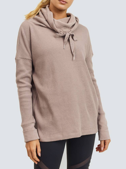 Taupe ribbed knit Lady Luxe pullover with cowl neck and drawstring detail.
