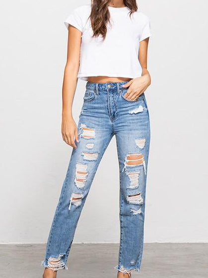 Light wash distressed Never Never Jeans; stylish, ripped denim for a trendy look.
