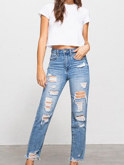 Light wash distressed Never Never Jeans; stylish, ripped denim for a trendy look.
