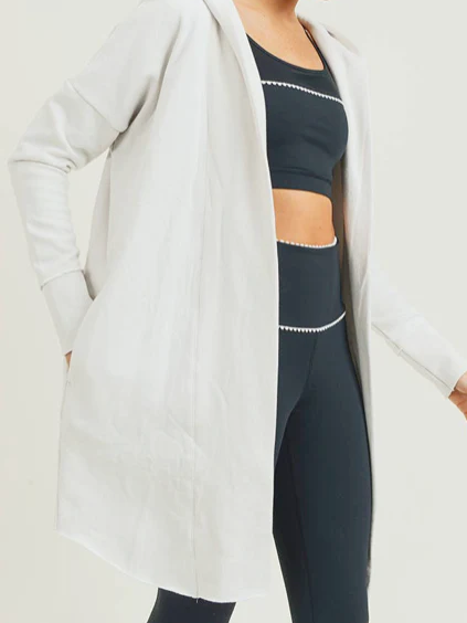 Off-white hooded longline cardigan, perfect for layering over workout clothes.
