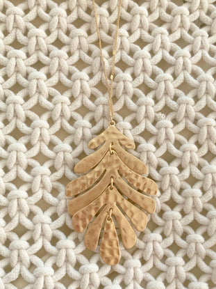 Gold Palm Paradise necklace with hammered leaf pendant
