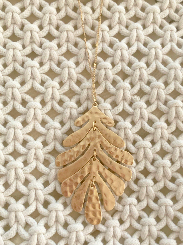 Gold Palm Paradise necklace with hammered leaf pendant
