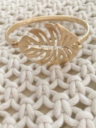 Gold leaf bangle bracelet featuring a unique monstera leaf design.
